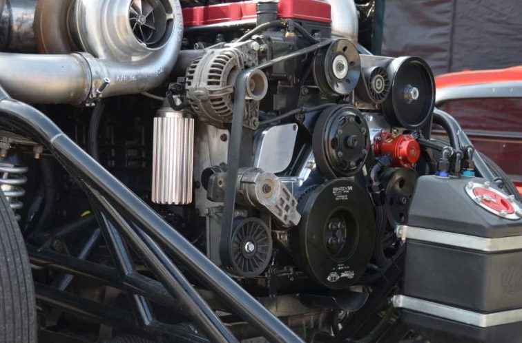 The engine of a car is shown in the background.
